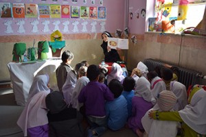 A tutor reads aloud with children - Read with Me in South Khorasan - Jan 2016